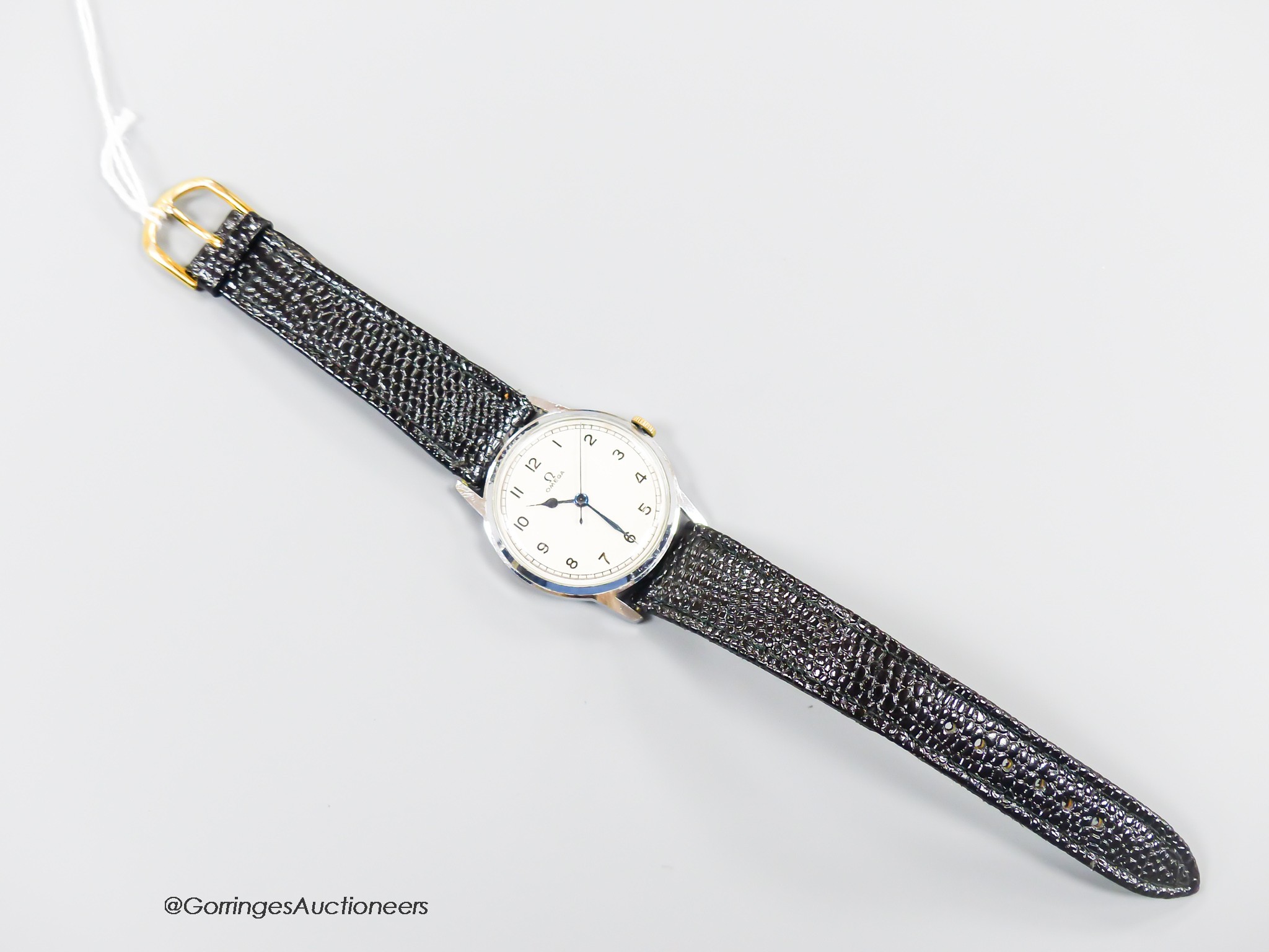 A gentleman's early 1940's stainless steel Omega manual wind wrist watch, case diameter 34mm, on later associated strap.